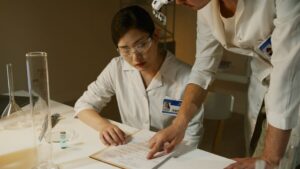Researchers in lab coats reviewing notes during a clinical study