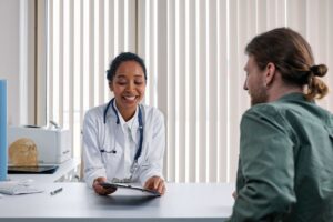 A doctor and patient talking during a consultation in a bright clinic