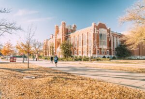 A historic university building surrounded by autumn trees