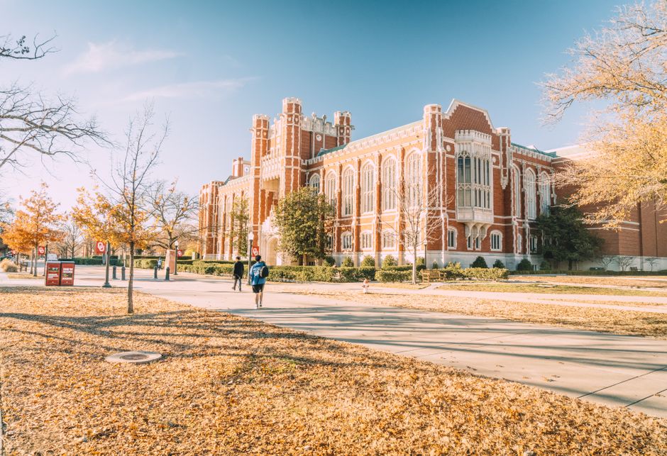 A historic university building surrounded by autumn trees